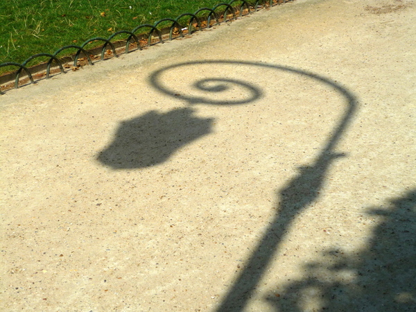 Shadow of lamp post in Place des Vosges © French Moments