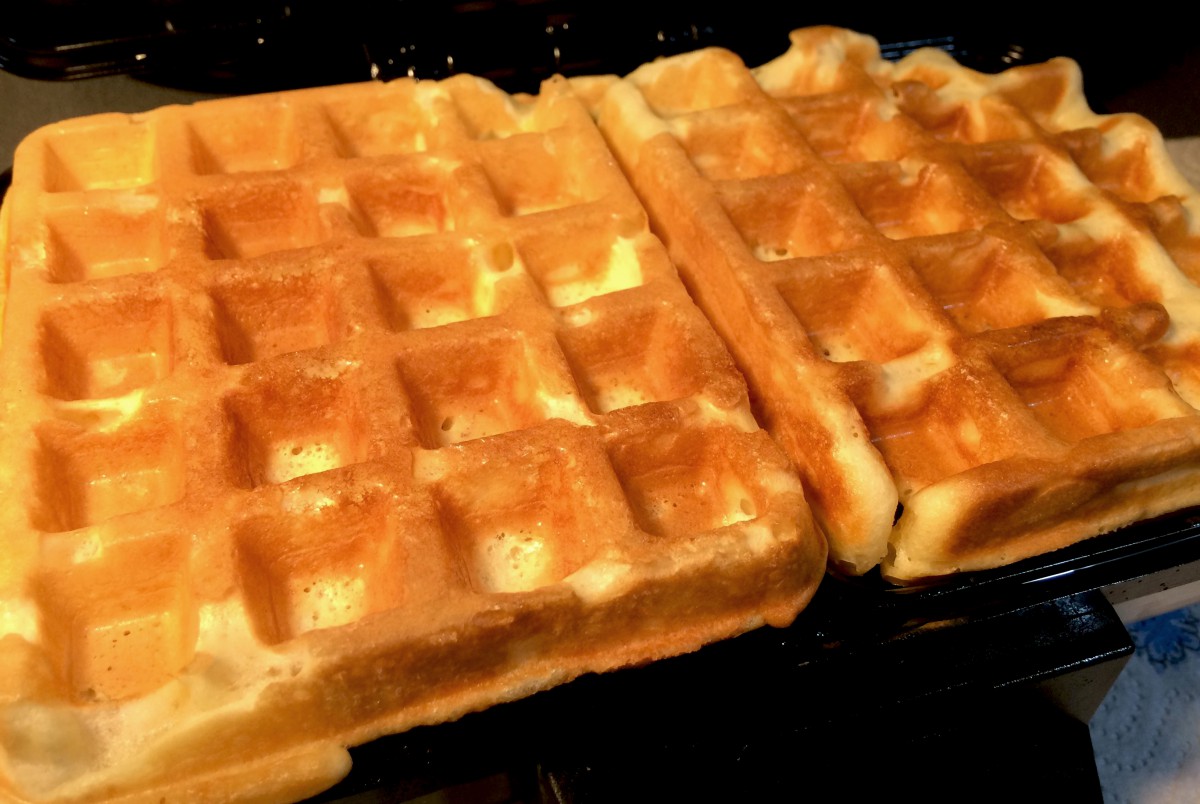 Waffles cooking on a waffle maker © French Moments