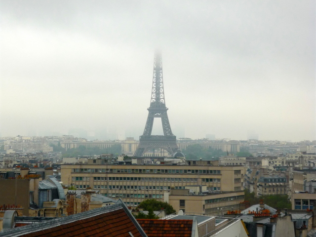 Eiffel tower with its top in the clouds © French Moments