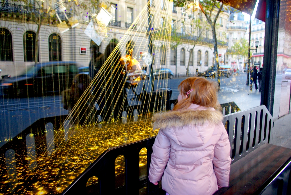 Little Girl in front of Christmas window display of Galeries Lafayette copyright French Moments