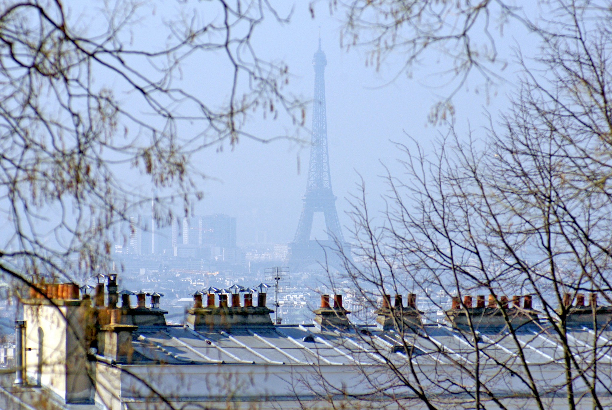 The Eiffel Tower seen from afar on a Sunny day in Montmartre © French Moments