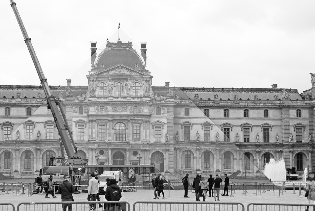The installation of JR's work onto the glass Pyramid of the Louvre is nearly completed - the optical illusion creates a perfect stunt! © French Moments