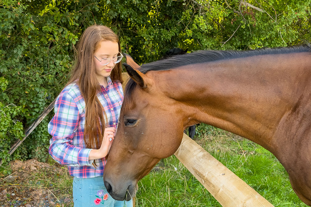 Our daughter with a horse in the Pays d'Auge