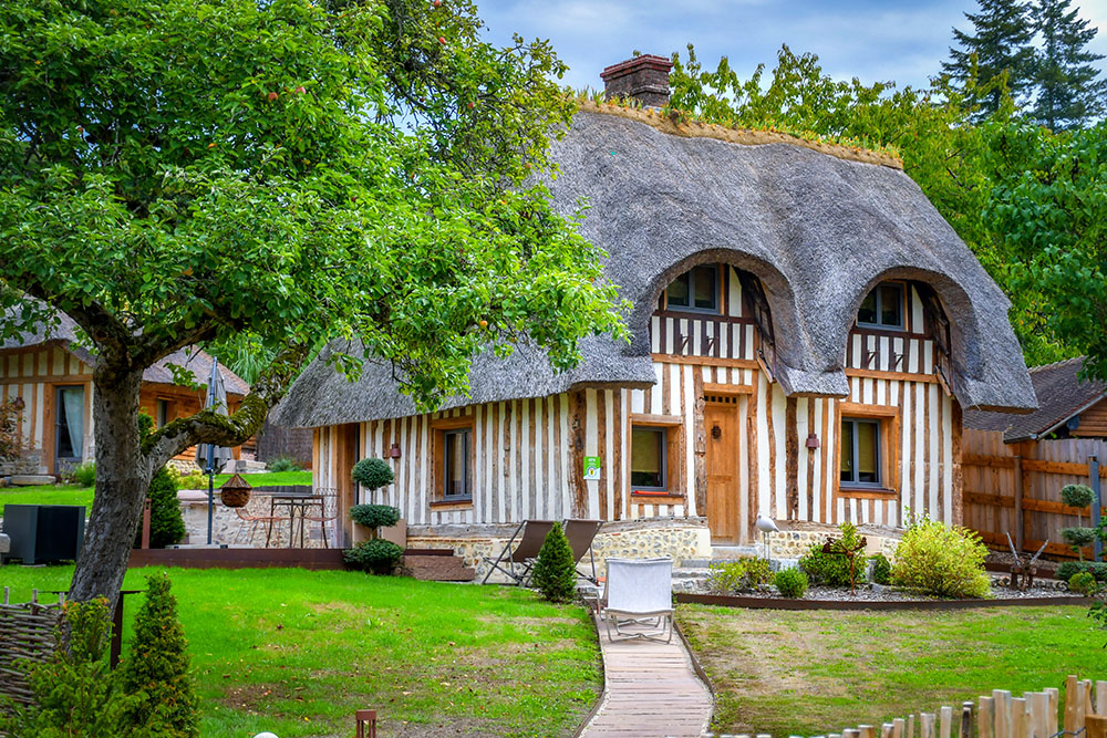 A half-timbered thatched cottage in Hermival-les-Vaux, Pays d'Auge
